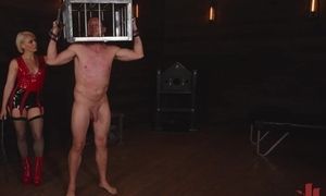 Restrained Submissive With His Head In A Cage